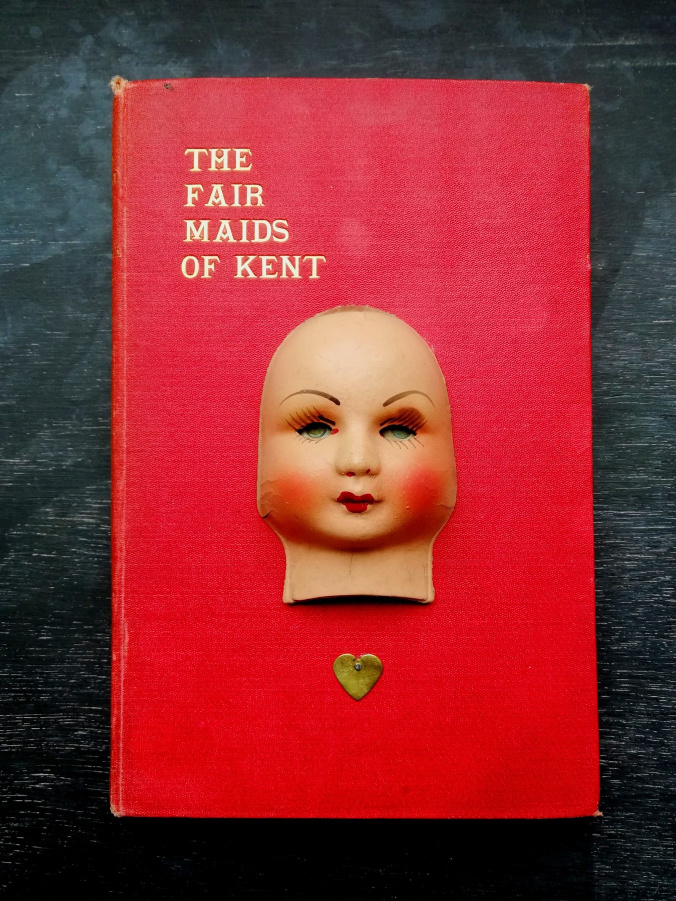 antique papiermache doll <br/> on vintage book <br/> 14 x 21.5cm <br/> £150