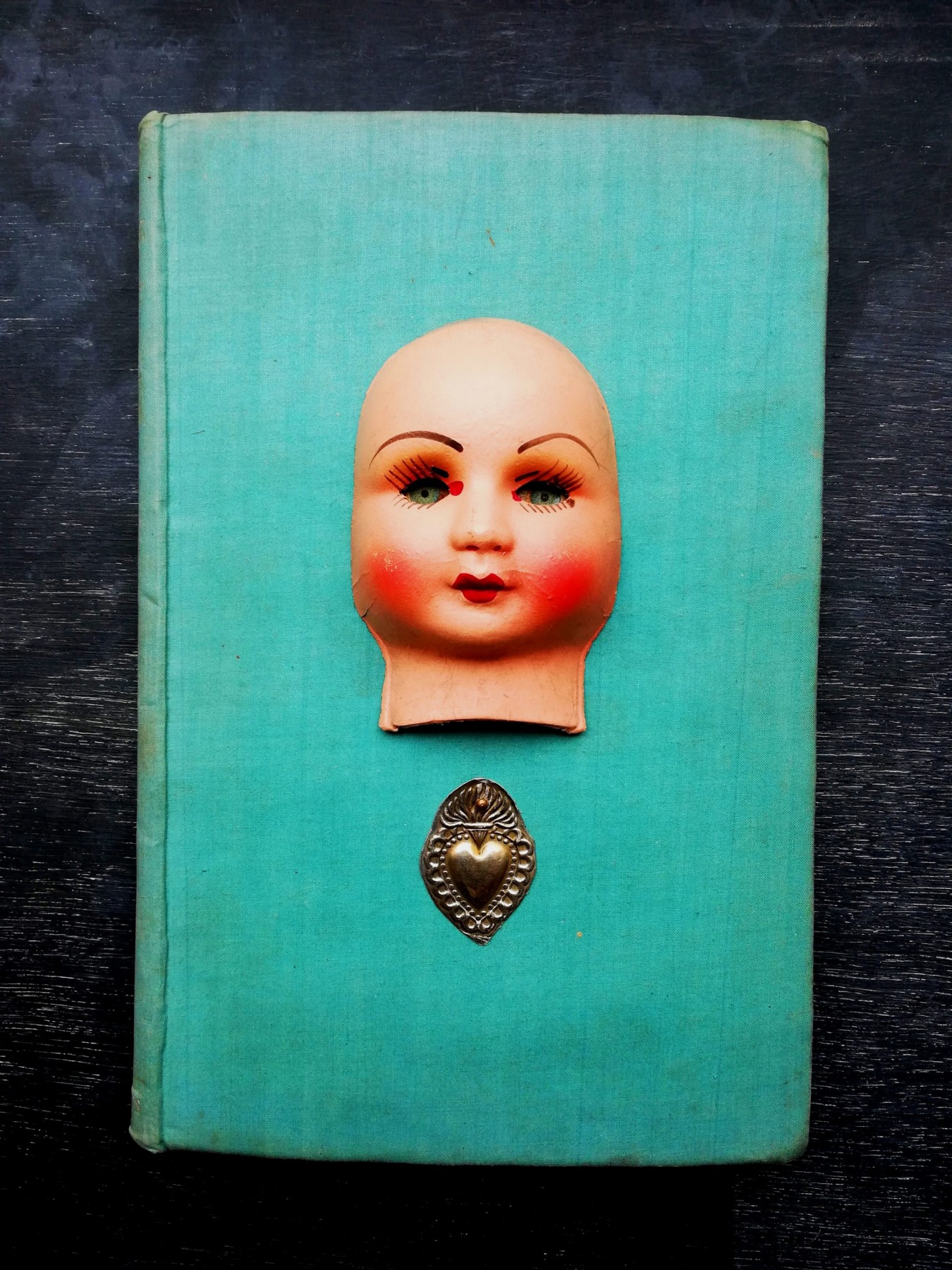 antique papiermache doll <br/> on vintage book <br/>14.5 x 22cm <br/>£150