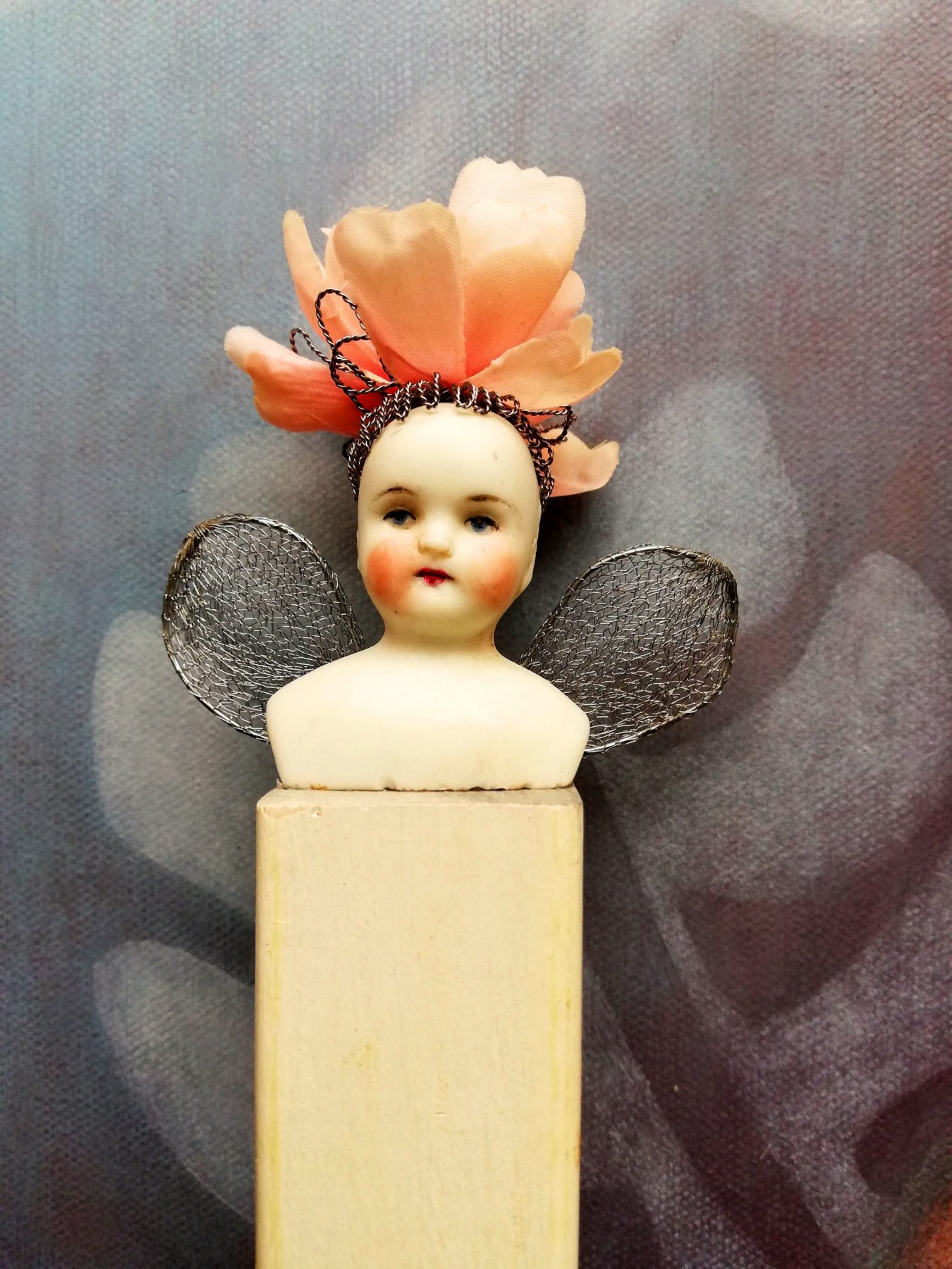 antique porcelain doll <br/> on ooden plinth <br/> 3 x 13cm (excl. wings) <br/> £80
